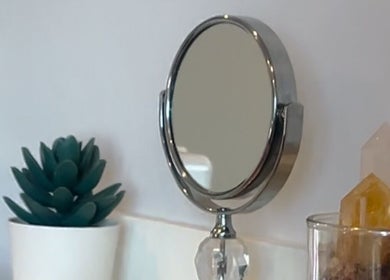 Round mirror with crystals and plant decor at LadyFace, Rancho Cucamonga, California, US.