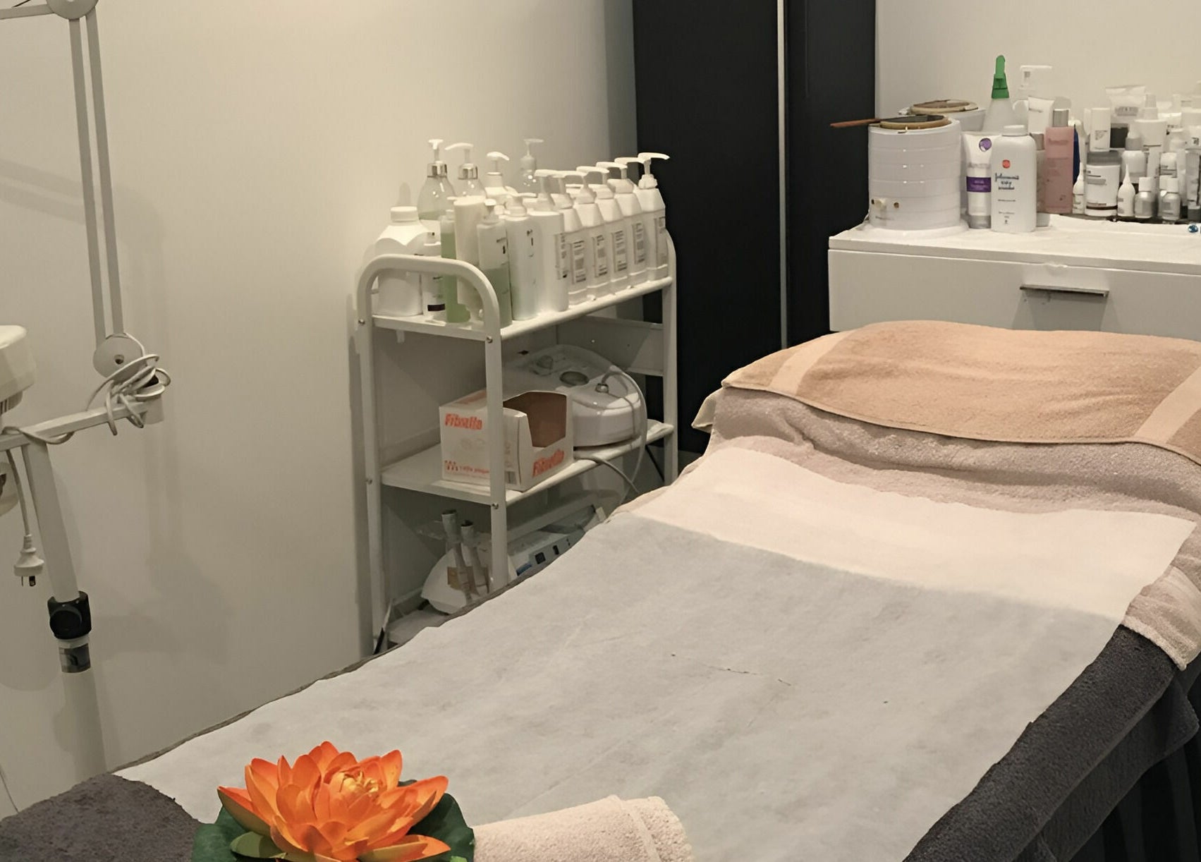 Belle Isle Manly's relaxing treatment room in Manly, New South Wales, AU, featuring a massage bed and spa products.