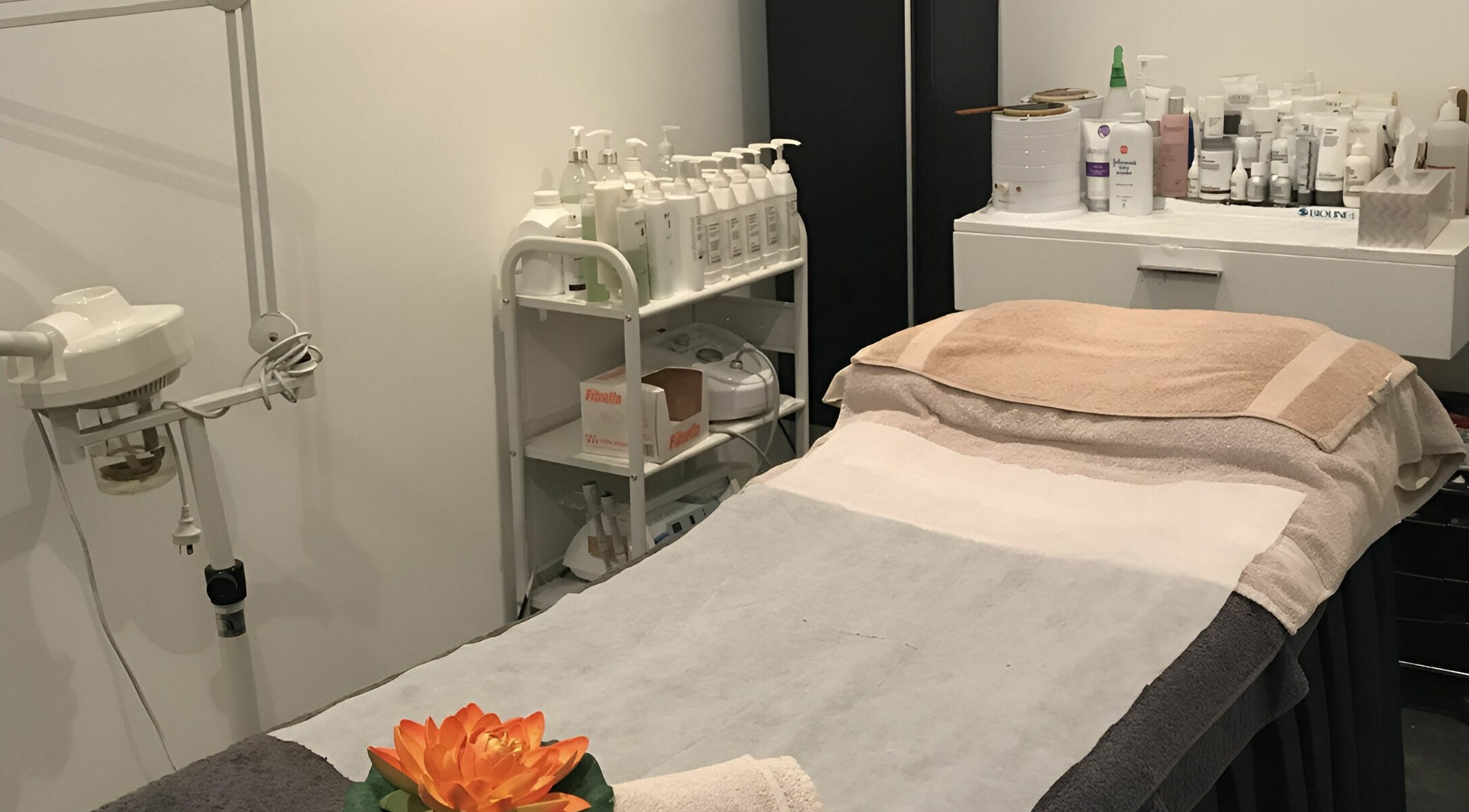 Belle Isle Manly's relaxing treatment room in Manly, New South Wales, AU, featuring a massage bed and spa products.