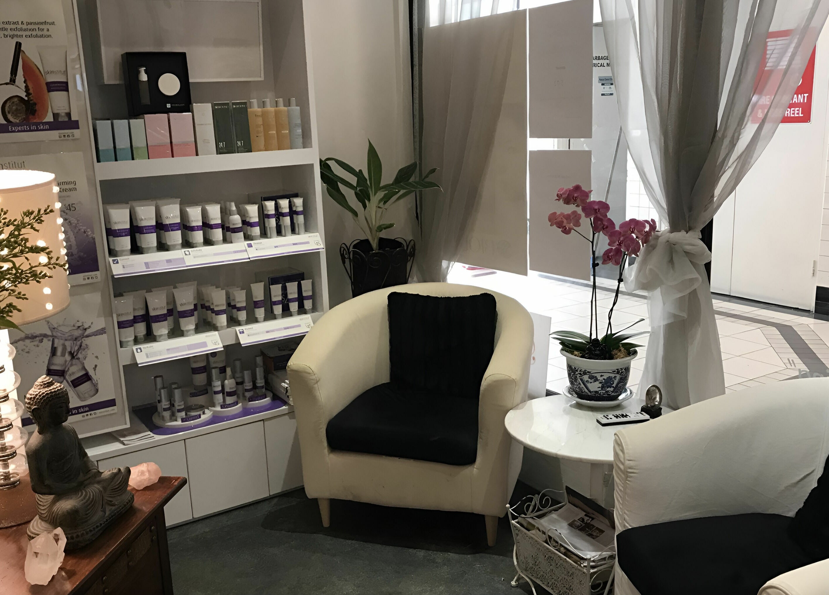 Cozy waiting area with products at Belle Isle Manly, Manly, New South Wales, AU featuring a Buddha statue.