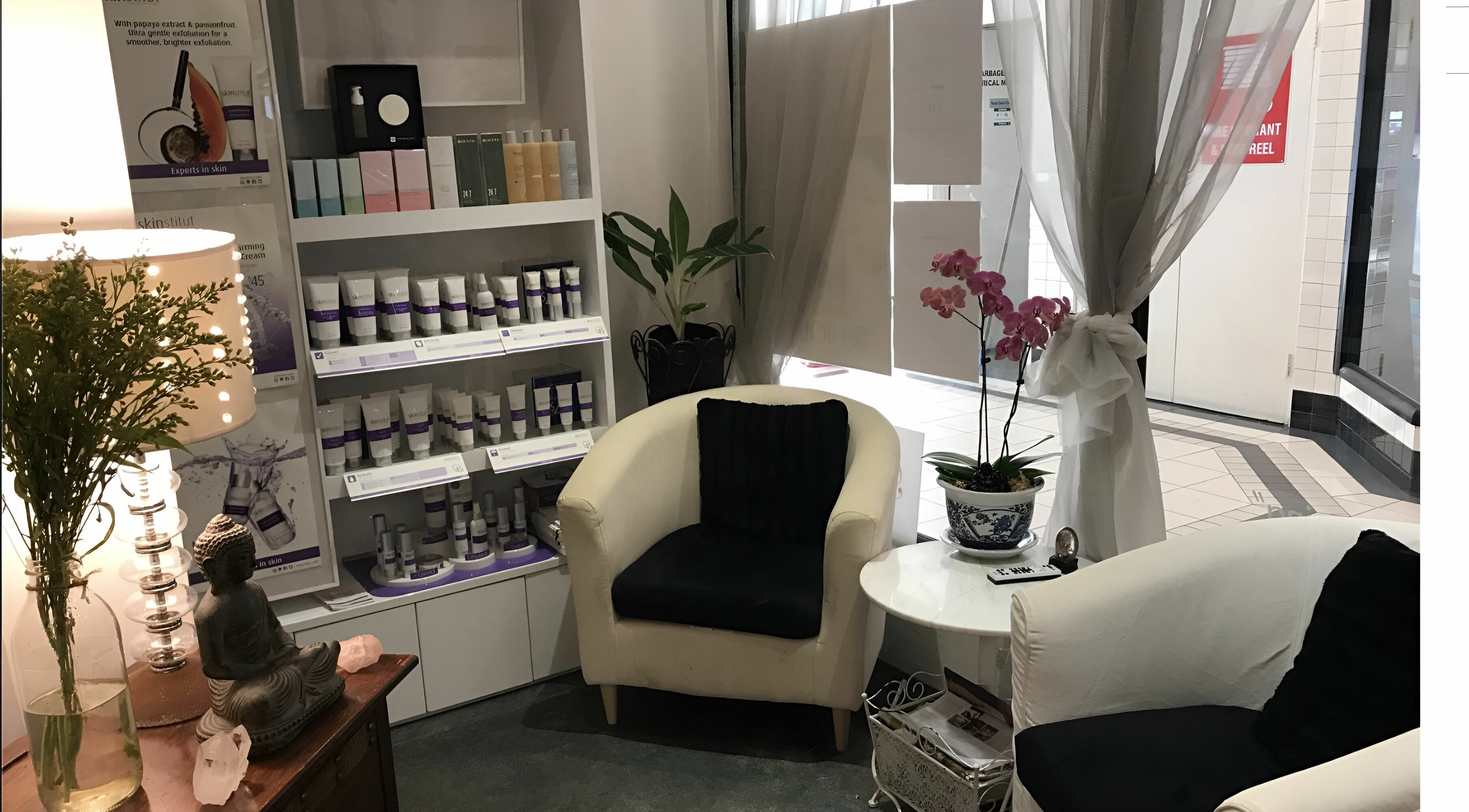 Cozy waiting area with products at Belle Isle Manly, Manly, New South Wales, AU featuring a Buddha statue.