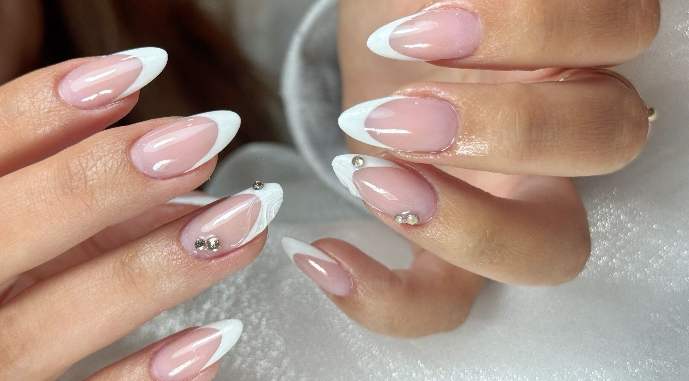 Chic French-style nails with embellishments at Bespoke Nail & Lash By Tran, Fairfield Heights, New South Wales, AU.