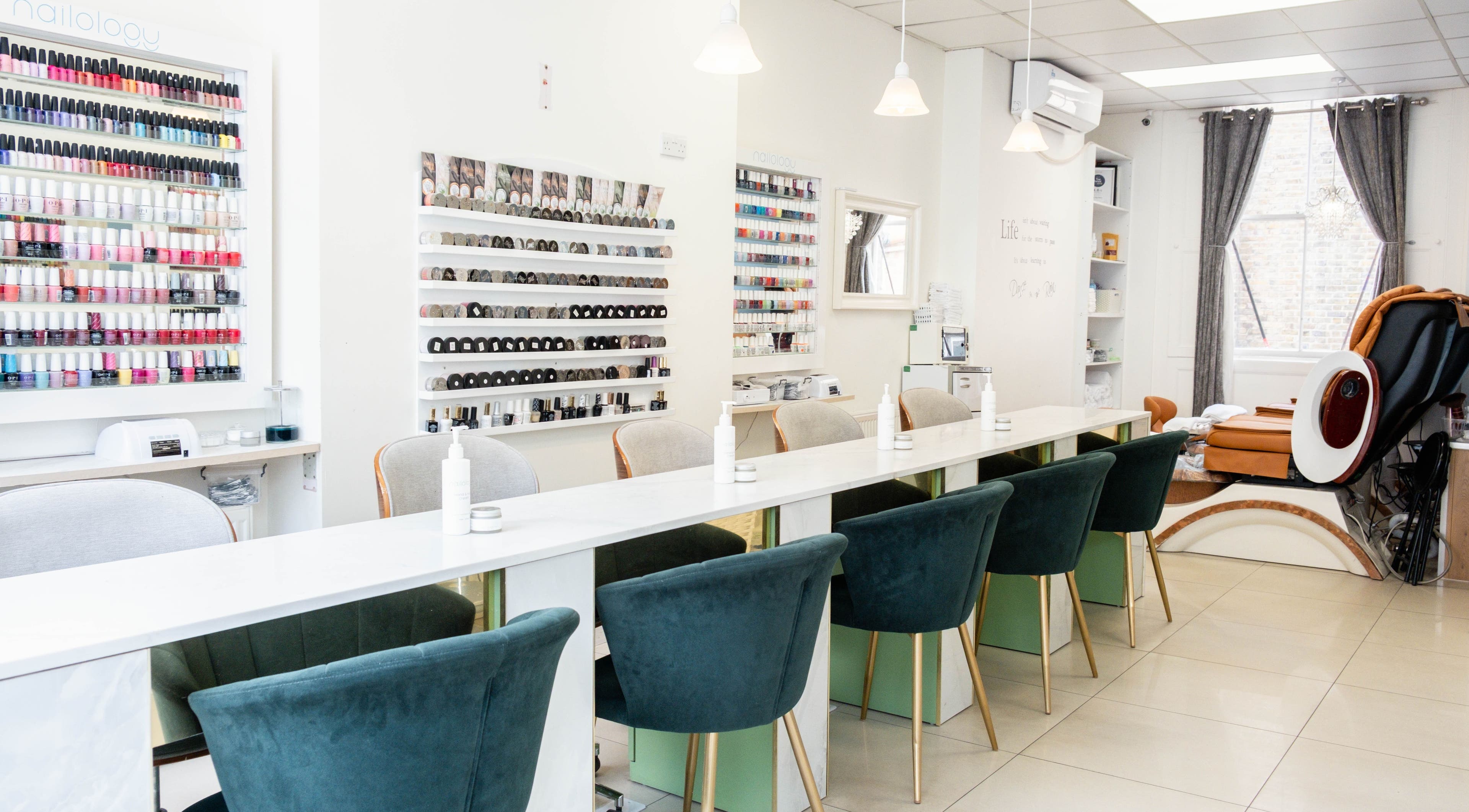 Interior of Tip Top Nails, a modern salon in London, England, GB with sleek nail stations and color displays.
