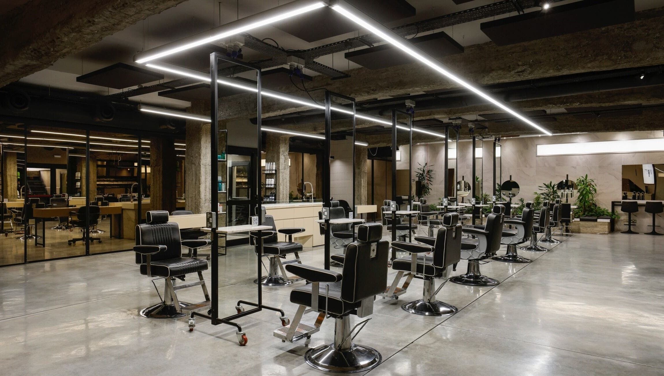 Spacious modern interior of HAIR ETC. Studio in Nicosia, CY featuring stylish salon chairs and mirrors.