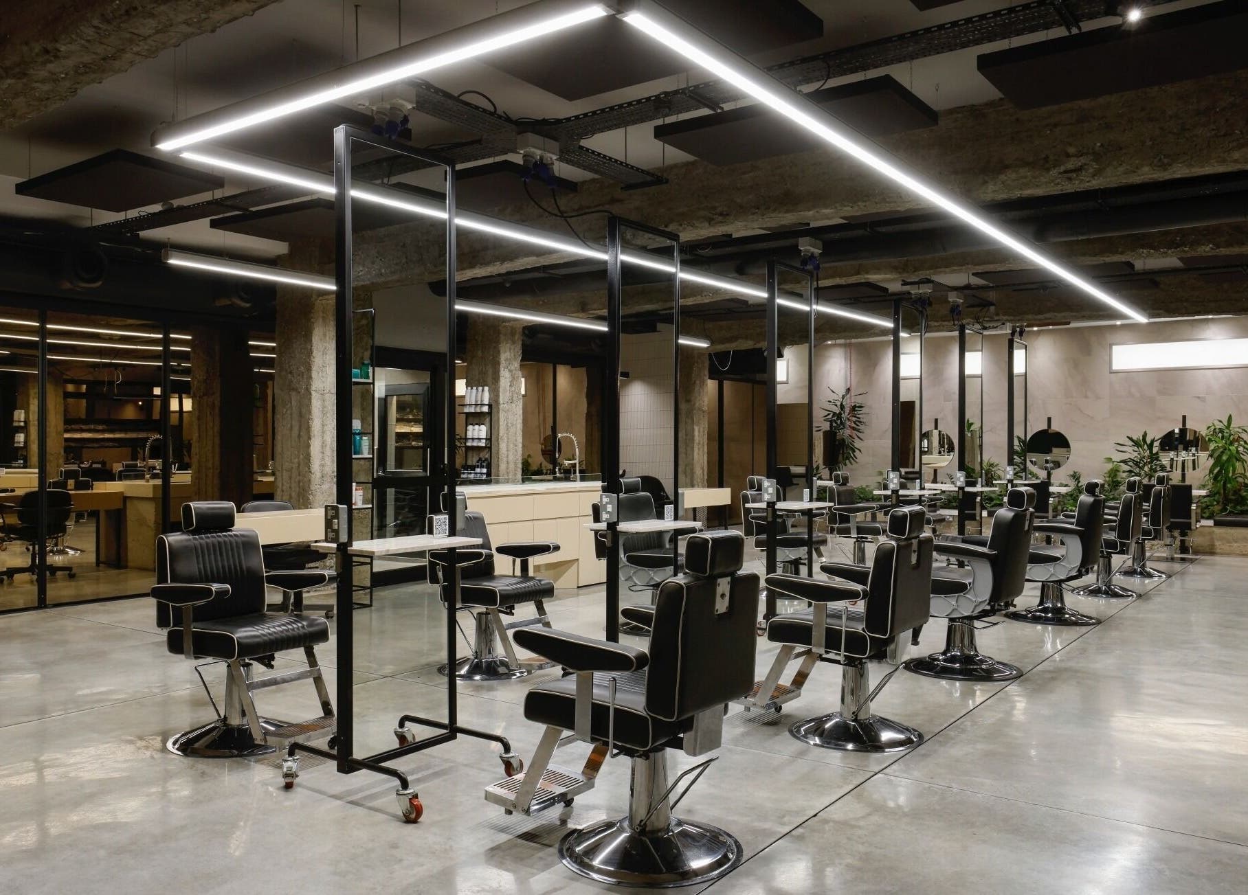 Spacious modern interior of HAIR ETC. Studio in Nicosia, CY featuring stylish salon chairs and mirrors.