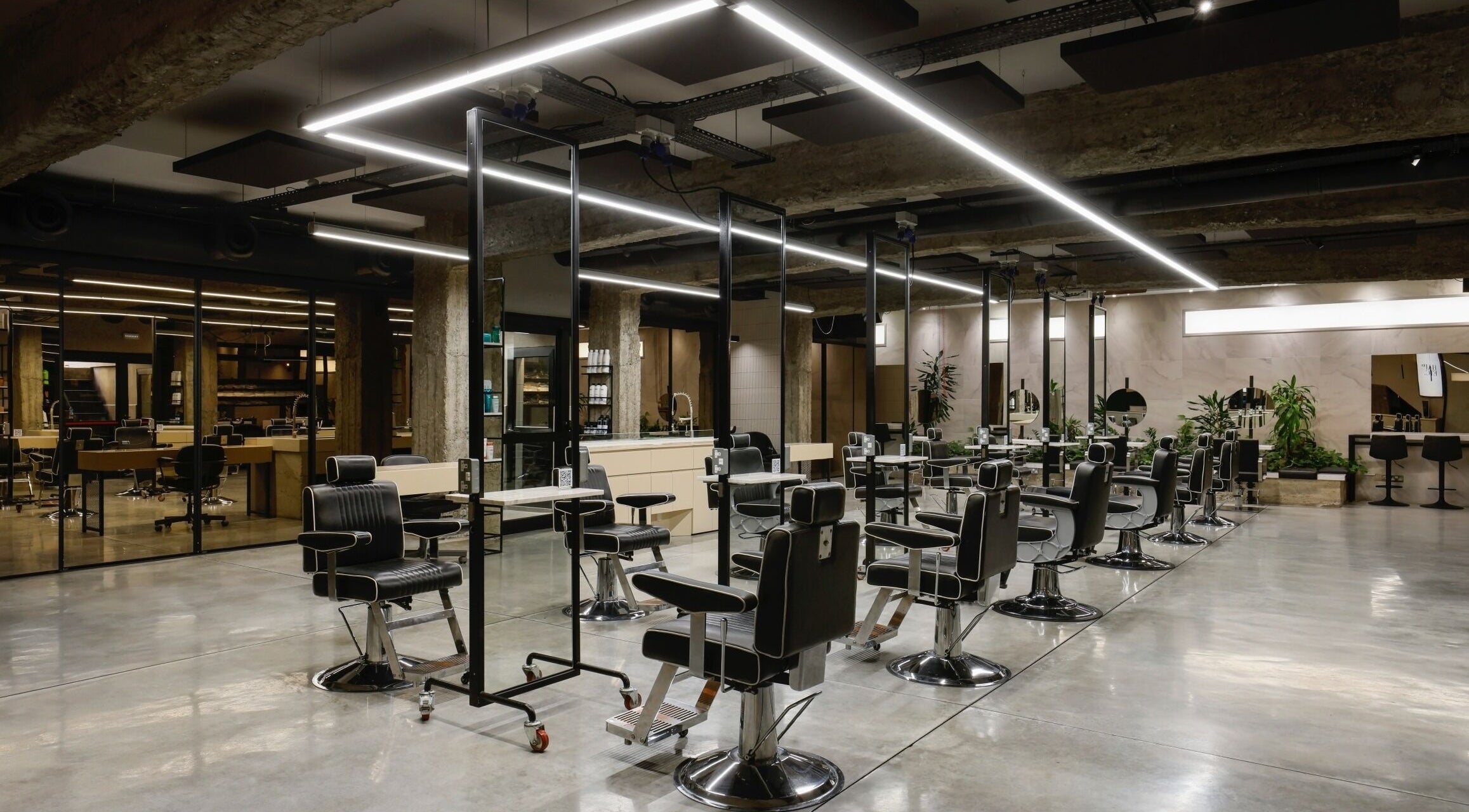 Spacious modern interior of HAIR ETC. Studio in Nicosia, CY featuring stylish salon chairs and mirrors.