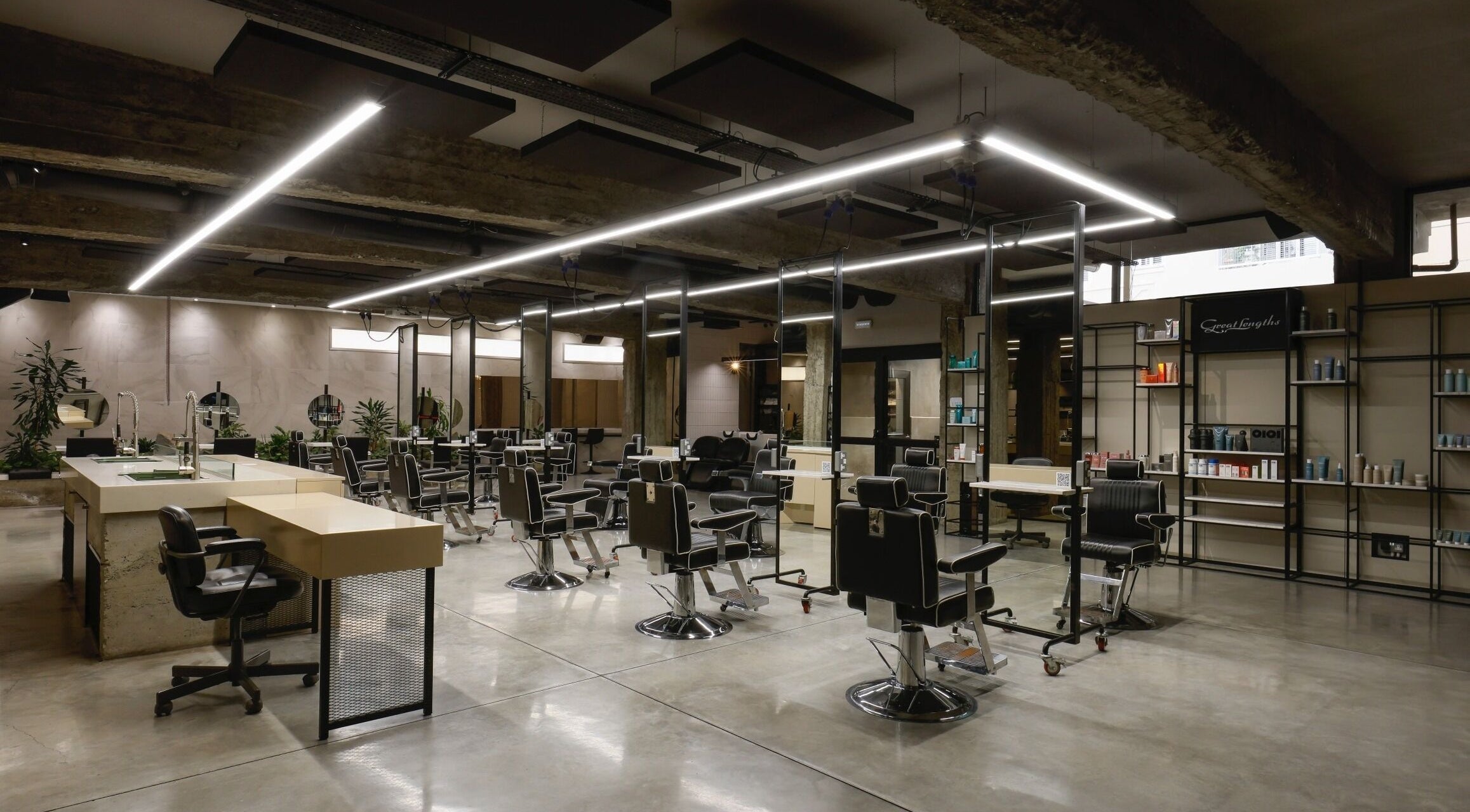Modern interior of HAIR ETC. Studio in Nicosia, CY featuring sleek black salon chairs and elegant lighting.