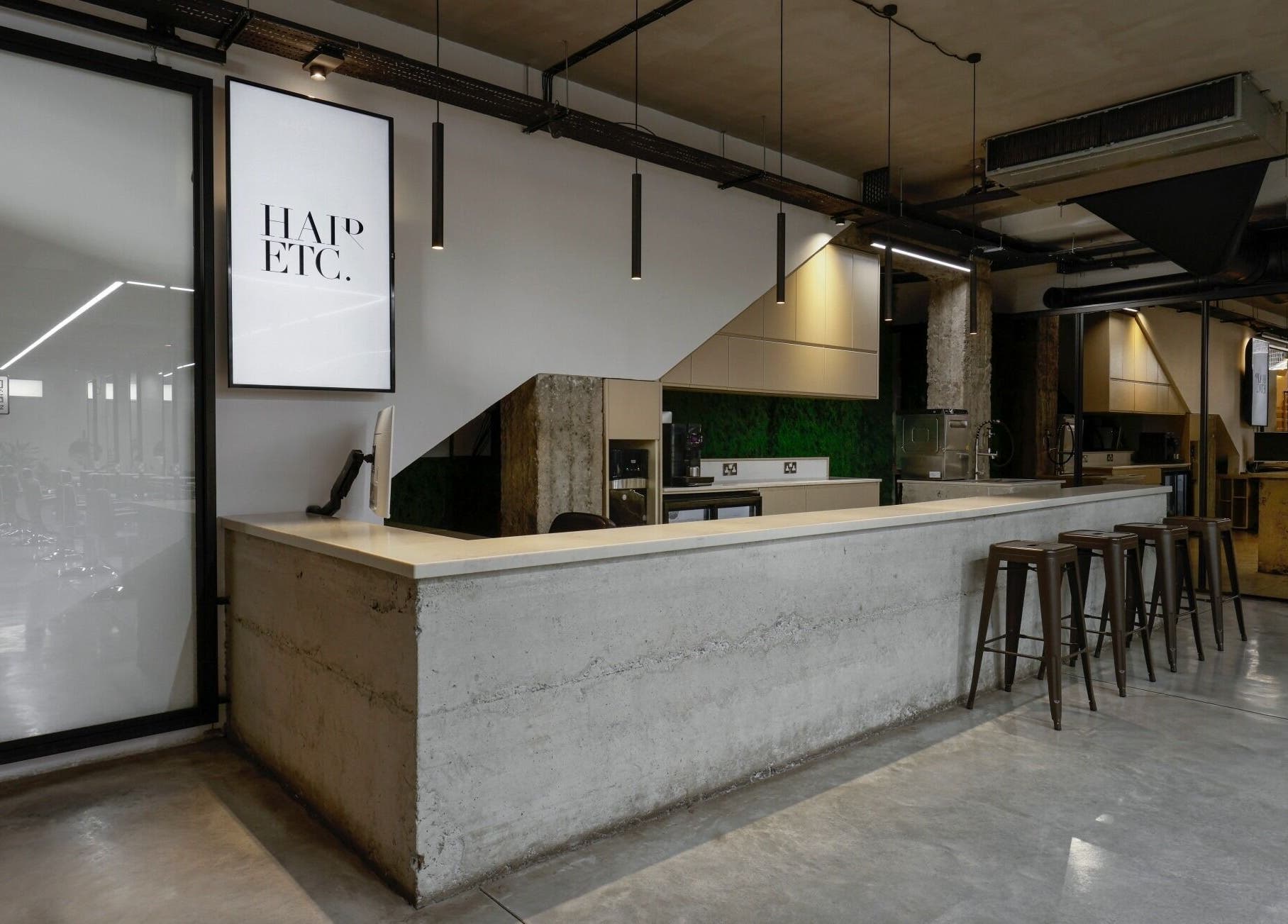 Modern reception at HAIR ETC. Studio, Nicosia, CY, featuring sleek decor and stylish seating.