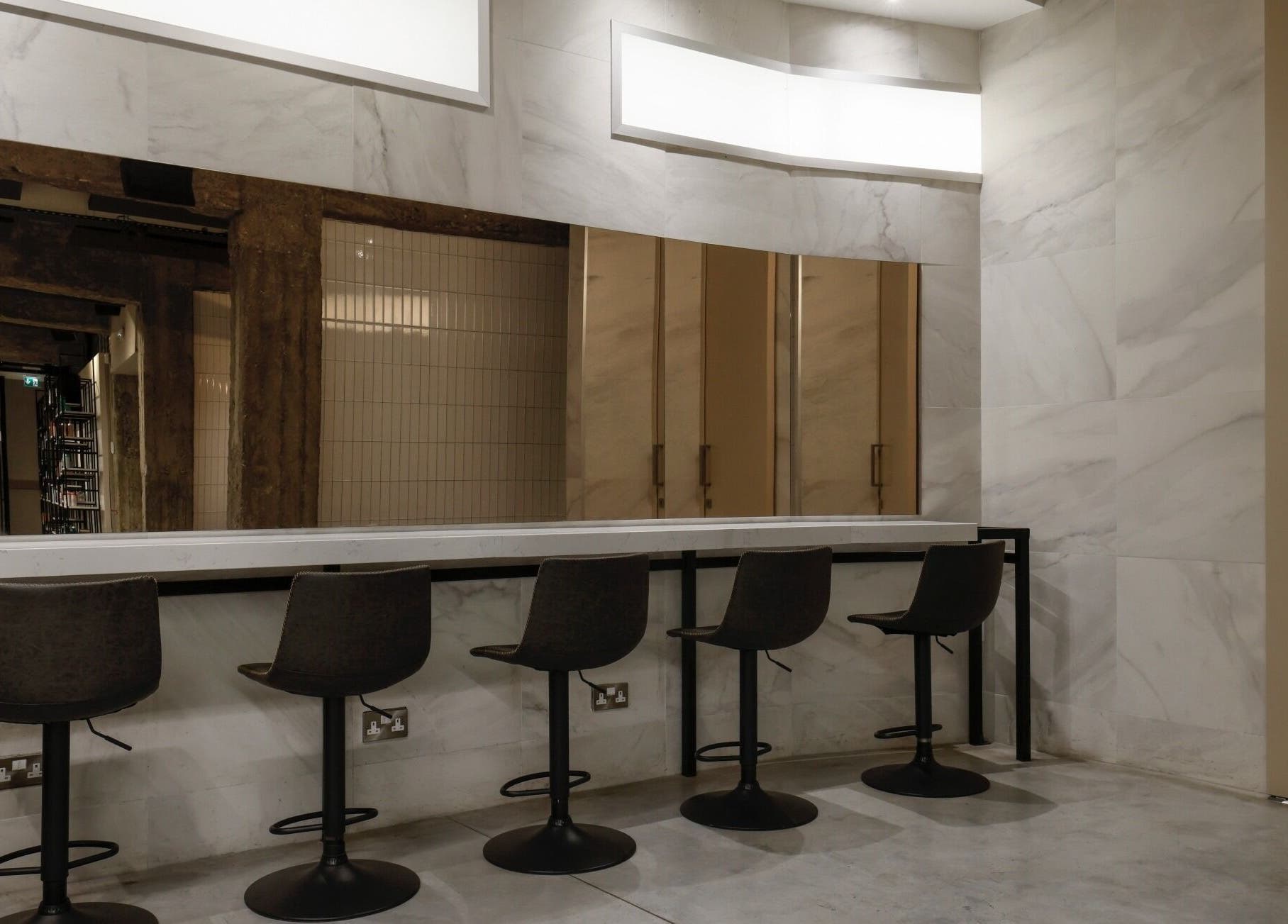 Modern salon seating at HAIR ETC. Studio, Nicosia, CY with sleek chairs and elegant decor.