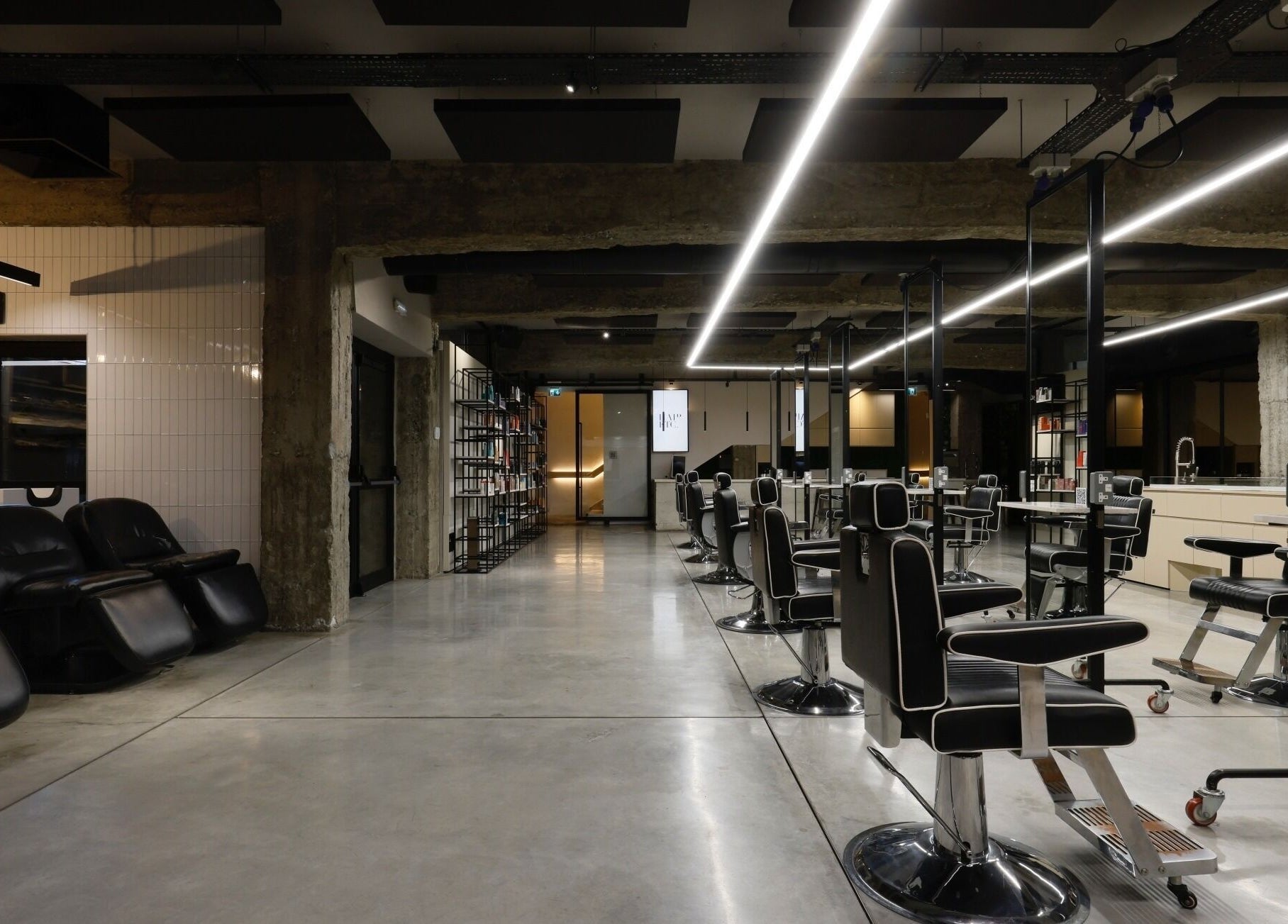 Modern interior of HAIR ETC. Studio in Nicosia, CY showcasing sleek styling chairs and a sophisticated design.