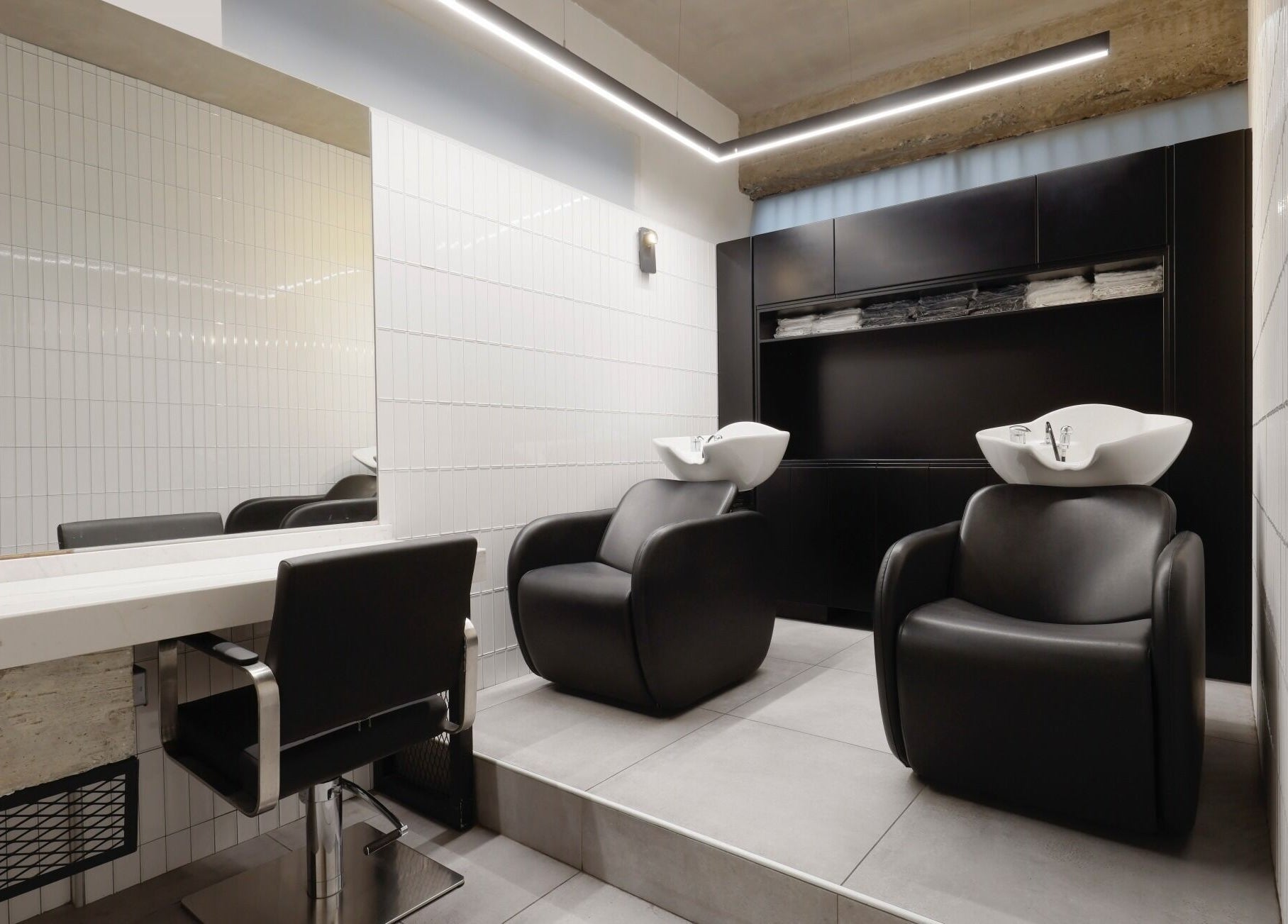 Modern salon interior at HAIR ETC. Studio, Nicosia, CY featuring stylish wash stations and minimalist design.