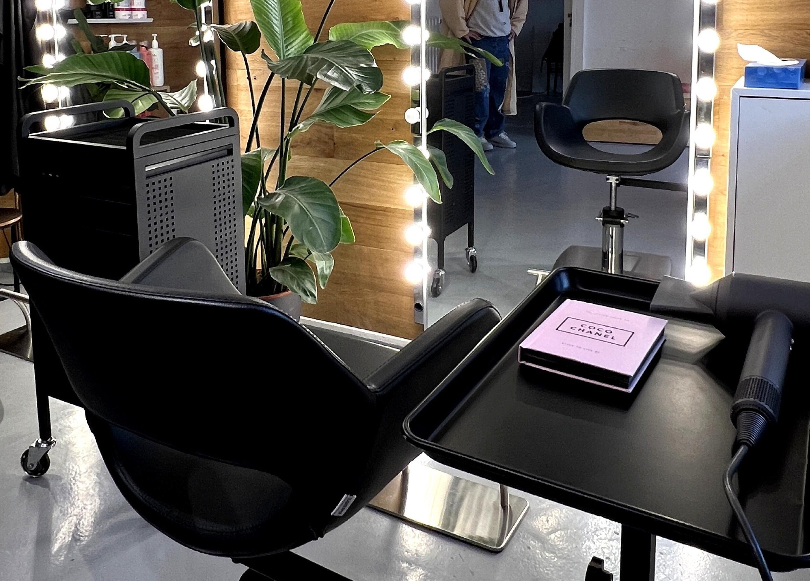 Modern beauty salon at David Nukri, Frederiksberg, Denmark, DK with sleek chairs and illuminated mirrors.