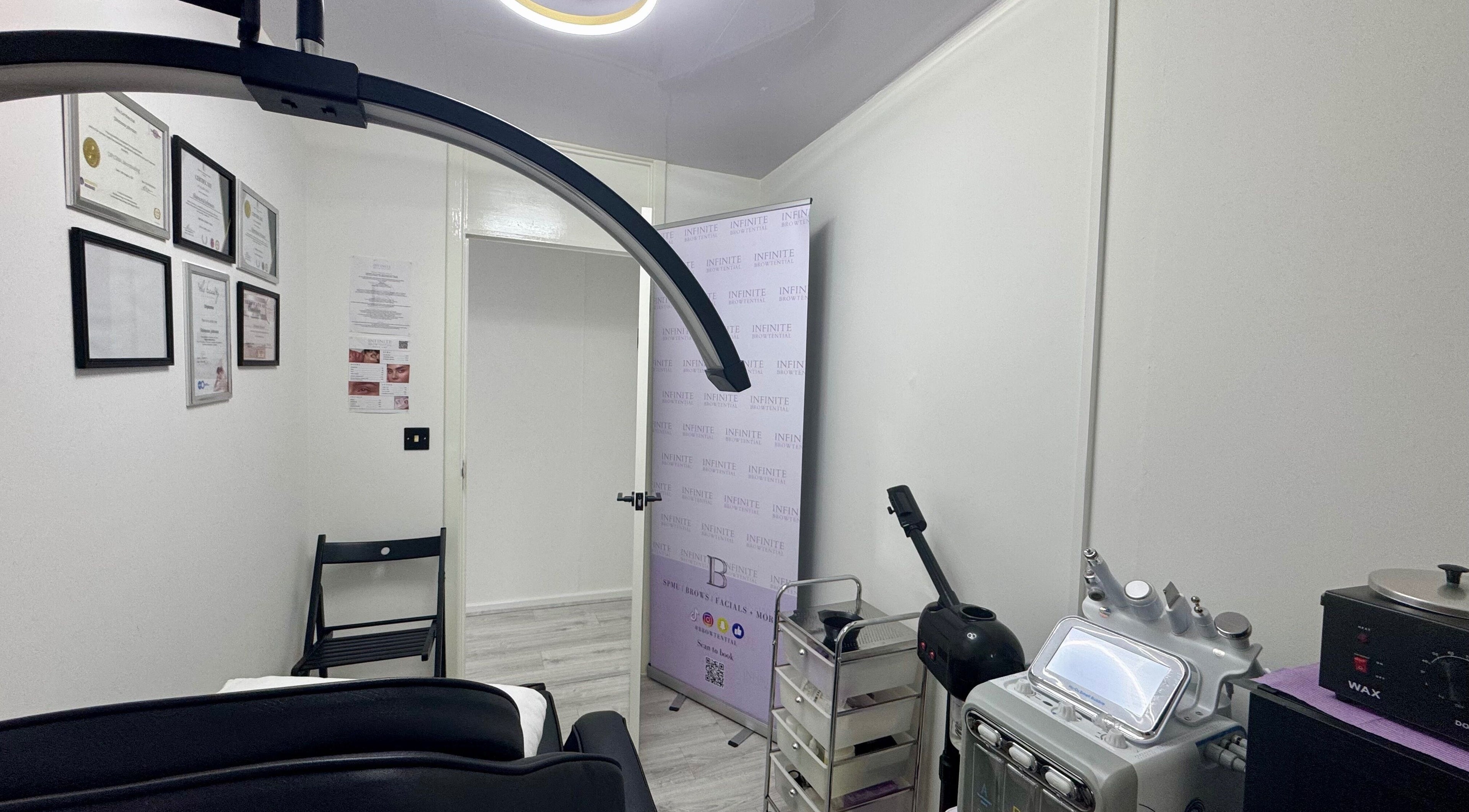 Infinite Browtential's modern treatment room in Birmingham, England, GB, featuring advanced beauty equipment.