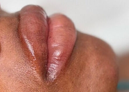 Close-up of glossy lips from Infinite Browtential, Birmingham, England, GB, showcasing beauty treatment.