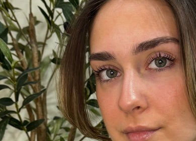 Close-up of styled lashes at Sculpt Studio - Studio des Cils, Laval, Québec, CA featuring lush greenery.