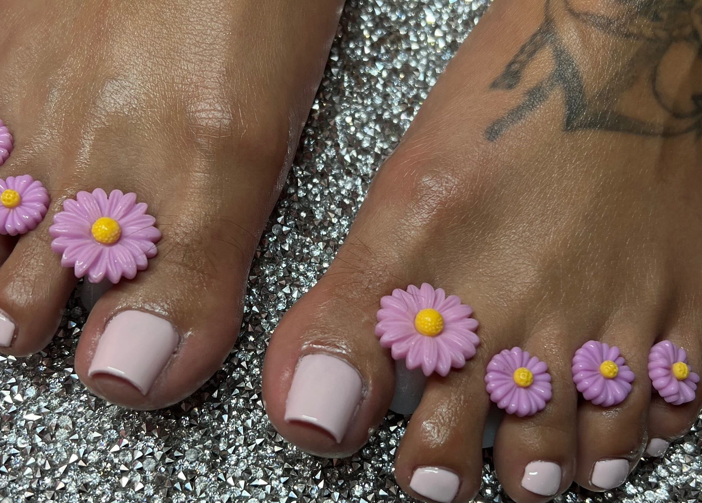 Elegant pedicure with pink daisy accents at Pink Sphinx Nails, Binbrook, Ontario, CA.