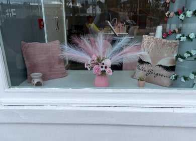 Elegant window decor at Nails and Beauty By Lauren Cowan, Ayr, Scotland, GB featuring plush pillows and floral accents.