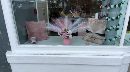 Elegant window decor at Nails and Beauty By Lauren Cowan, Ayr, Scotland, GB featuring plush pillows and floral accents.