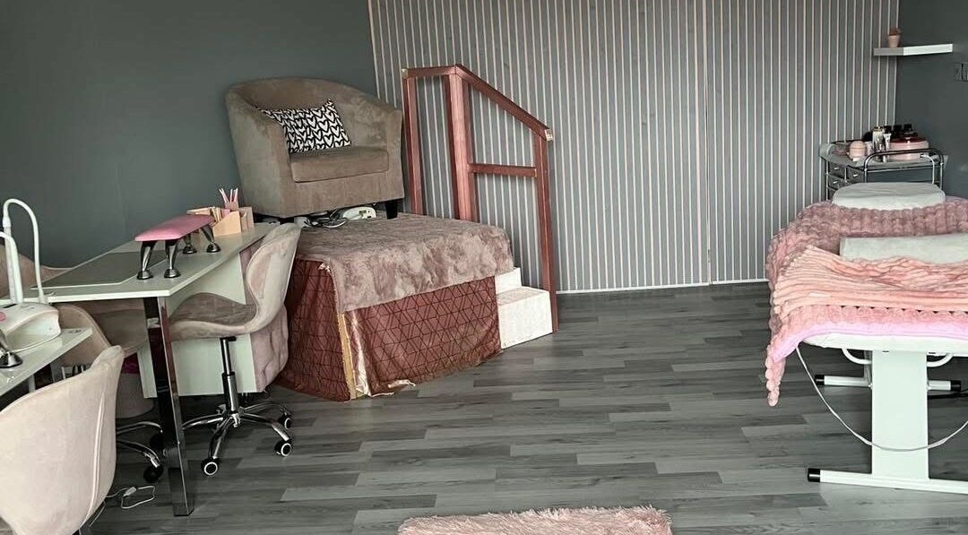 LJMs Beauty Bar's elegant setup with plush seating and a treatment bed in Ayr, Scotland, GB.