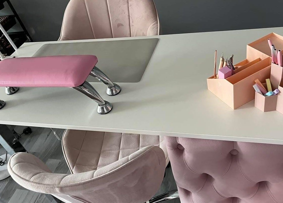 Elegant manicure station at LJMs Beauty Bar in Ayr, Scotland, GB with plush seating and colorful tools.