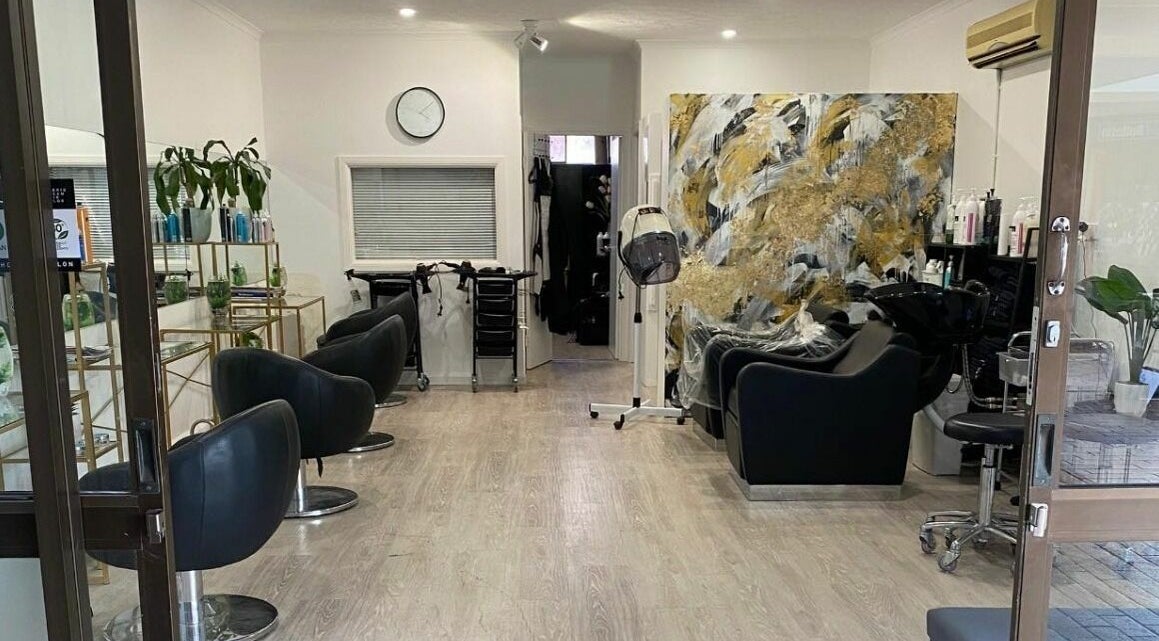 Modern interior of Shine Hair and Beauty in Currumbin Waters, Queensland, AU with sleek black chairs and decor.