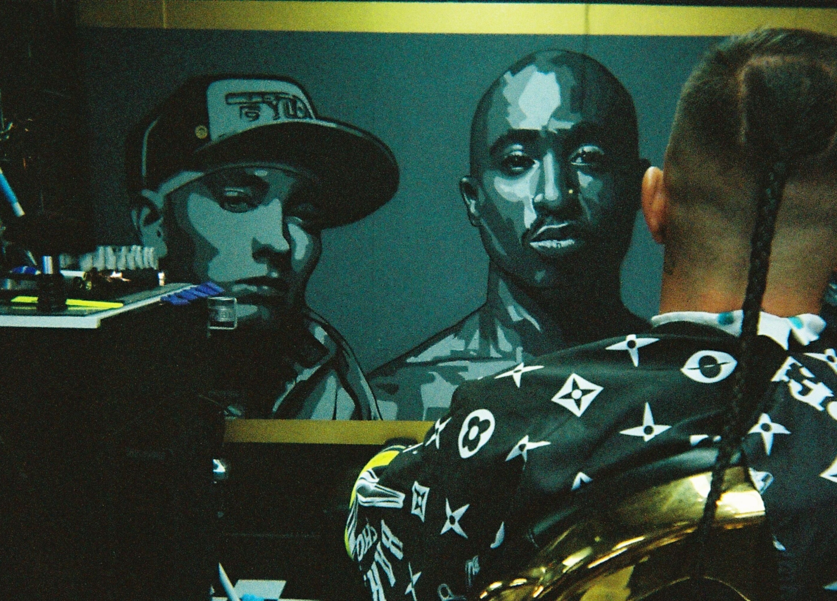 A client at Timeless Barber Co - Nerang enjoys a stylish haircut in Nerang, Queensland, AU, with vibrant wall art.