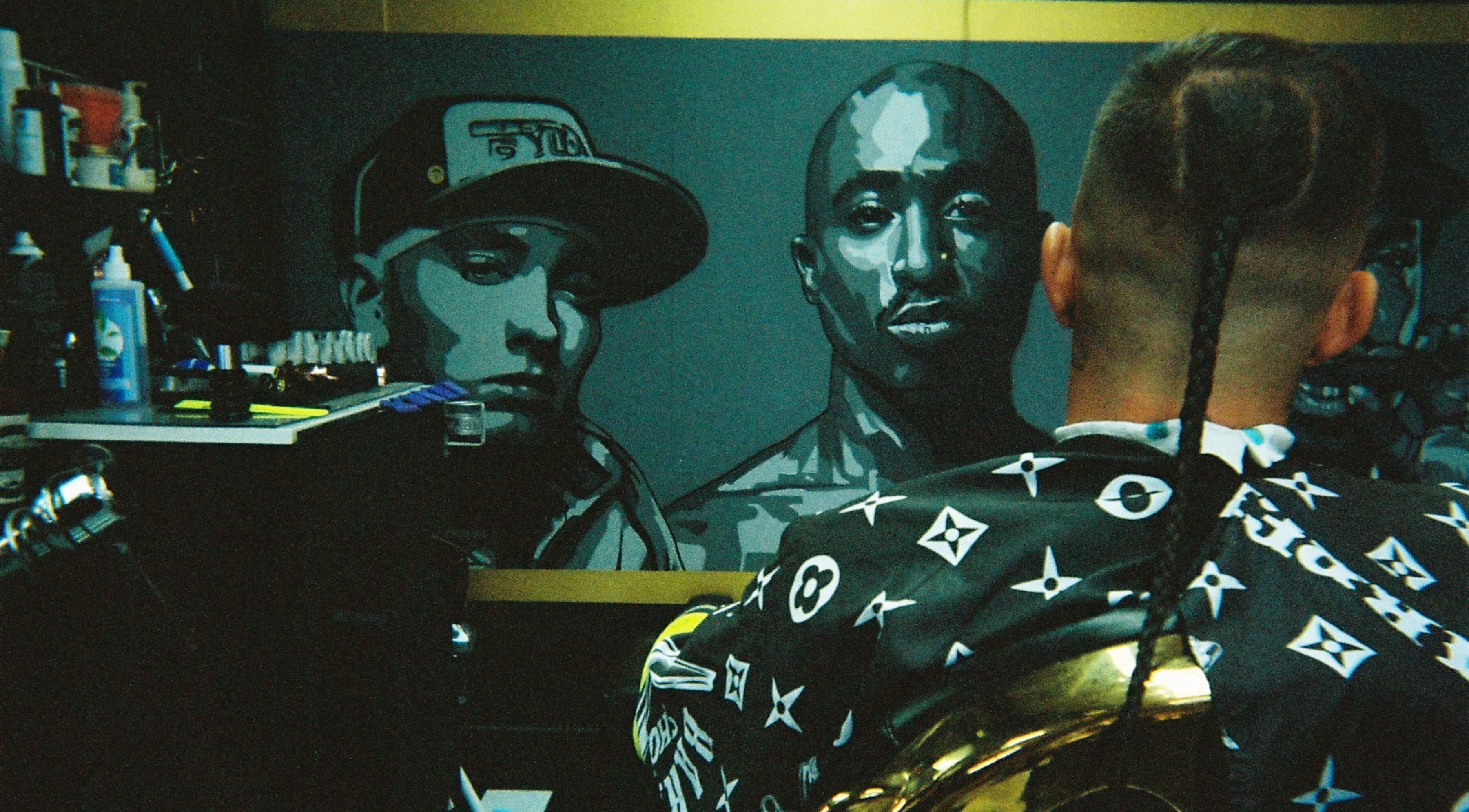 A client at Timeless Barber Co - Nerang enjoys a stylish haircut in Nerang, Queensland, AU, with vibrant wall art.