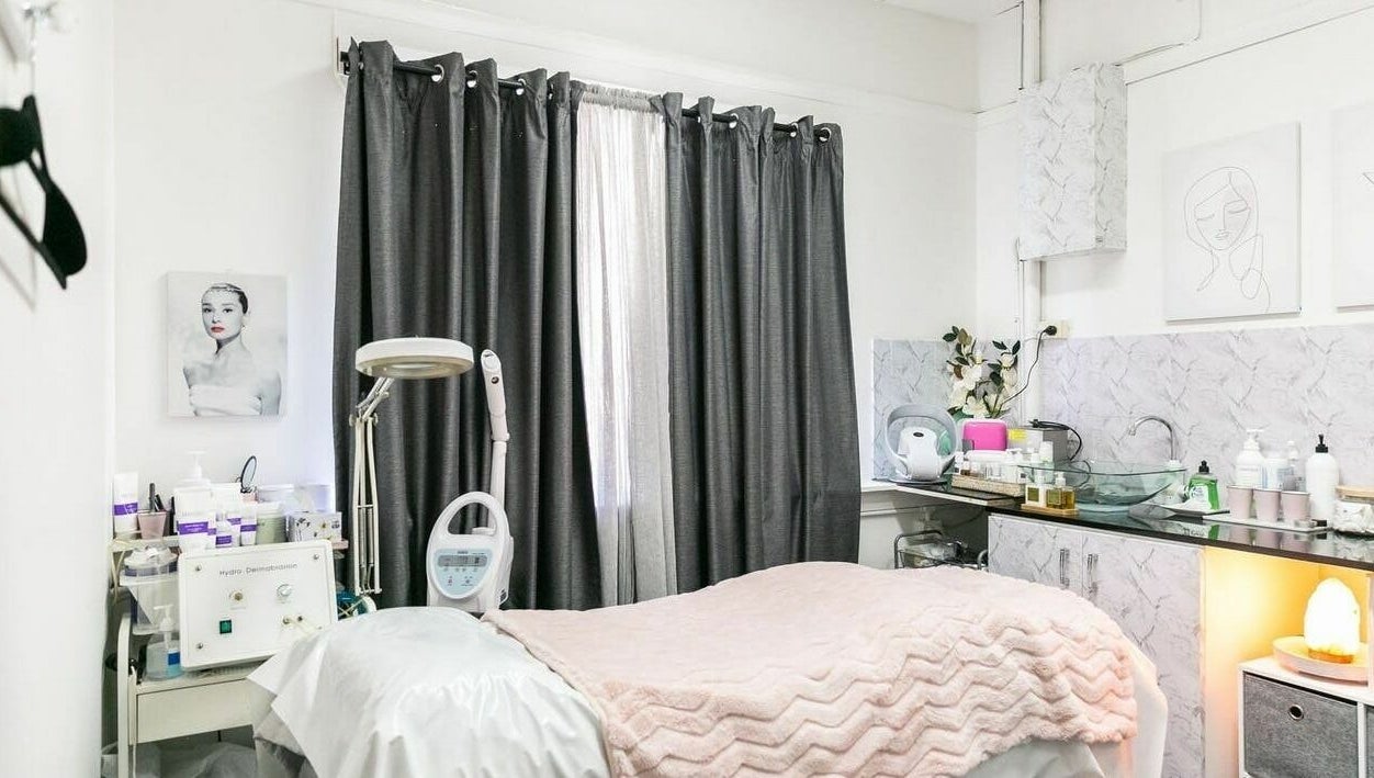 Treatment room at Precious Beautee Ashfield, New South Wales, AU, featuring cozy bedding and skincare equipment.
