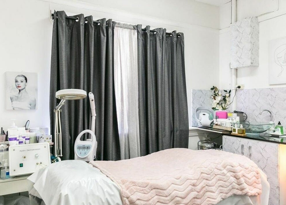 Treatment room at Precious Beautee Ashfield, New South Wales, AU, featuring cozy bedding and skincare equipment.