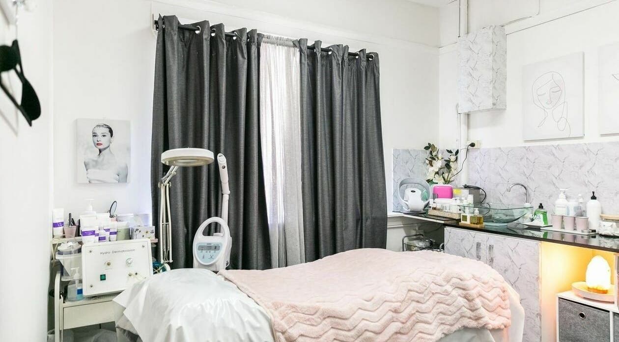 Treatment room at Precious Beautee Ashfield, New South Wales, AU, featuring cozy bedding and skincare equipment.