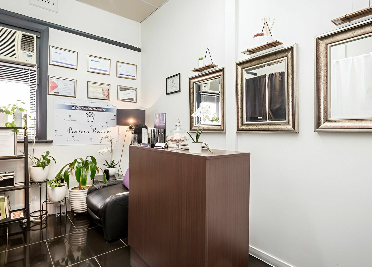 Chic reception area of Precious Beautee in Ashfield, New South Wales, AU with stylish decor and wall mirrors.