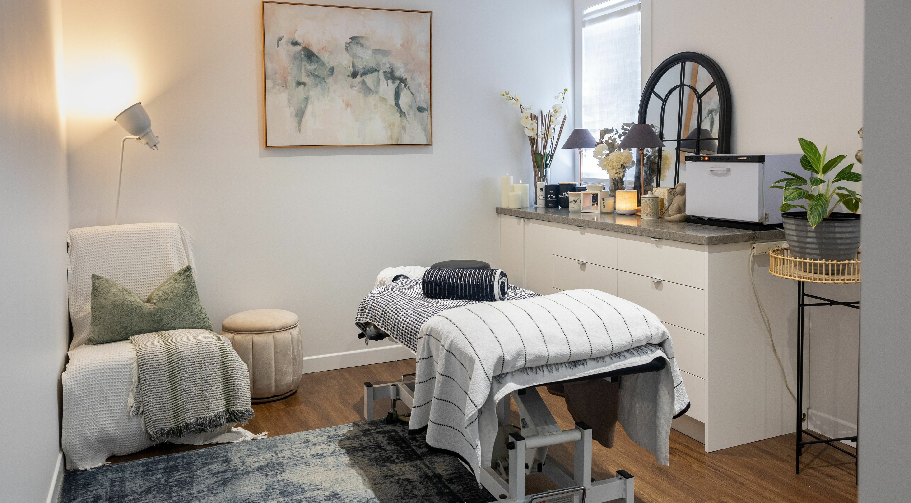 Cozy treatment room at Total Bliss Health and Beauty, Greenslopes, Queensland, AU with massage table and calming decor.