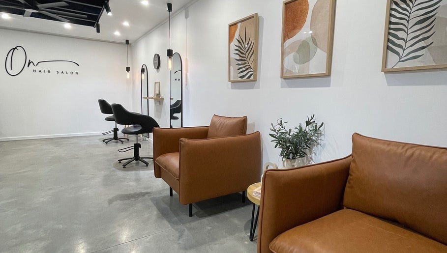 Elegant interior of Olivia Nipperess salon in Bellambi, New South Wales, AU with stylish seating and decor.