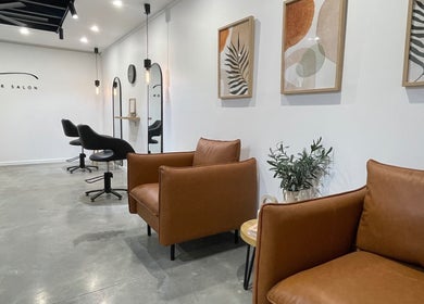 Elegant interior of Olivia Nipperess salon in Bellambi, New South Wales, AU with stylish seating and decor.