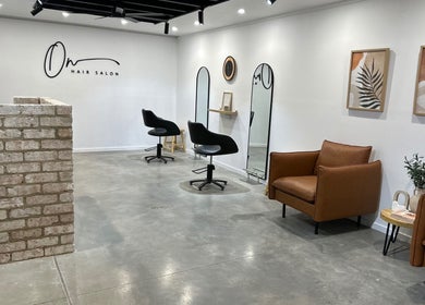 Modern interior of Olivia Nipperess salon in Bellambi, NSW. Stylish chairs and decor offer a relaxing ambiance.