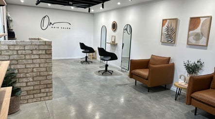 Modern interior of Olivia Nipperess salon in Bellambi, NSW. Stylish chairs and decor offer a relaxing ambiance.