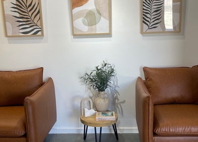 Stylish lounge at Olivia Nipperess, Bellambi, New South Wales, AU with leather chairs and modern art.
