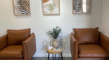 Stylish lounge at Olivia Nipperess, Bellambi, New South Wales, AU with leather chairs and modern art.