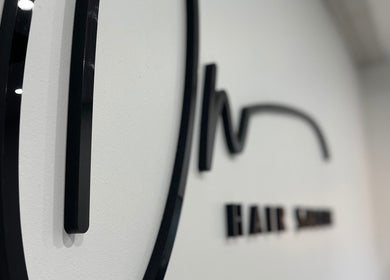 Modern salon sign inside Olivia Nipperess, Bellambi, New South Wales, AU showcasing sleek design.