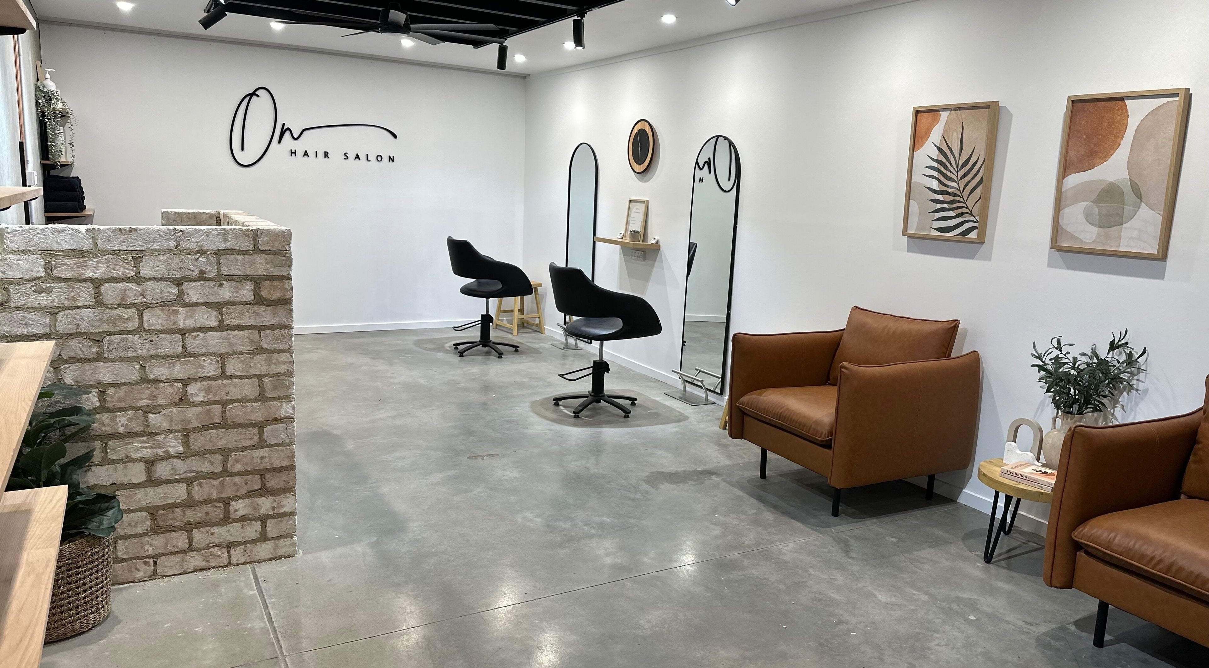 Sleek interior of Olivia N Hair Salon in Bellambi, New South Wales, AU with stylish chairs and decor.