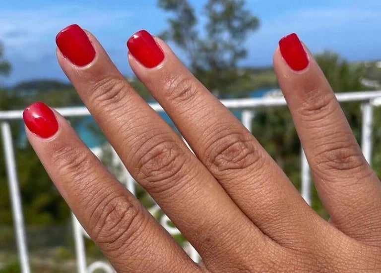 Vibrant red nails at Lacquered Lounge, Town Of St. George, St. George's Parish, BM, offering stunning views.