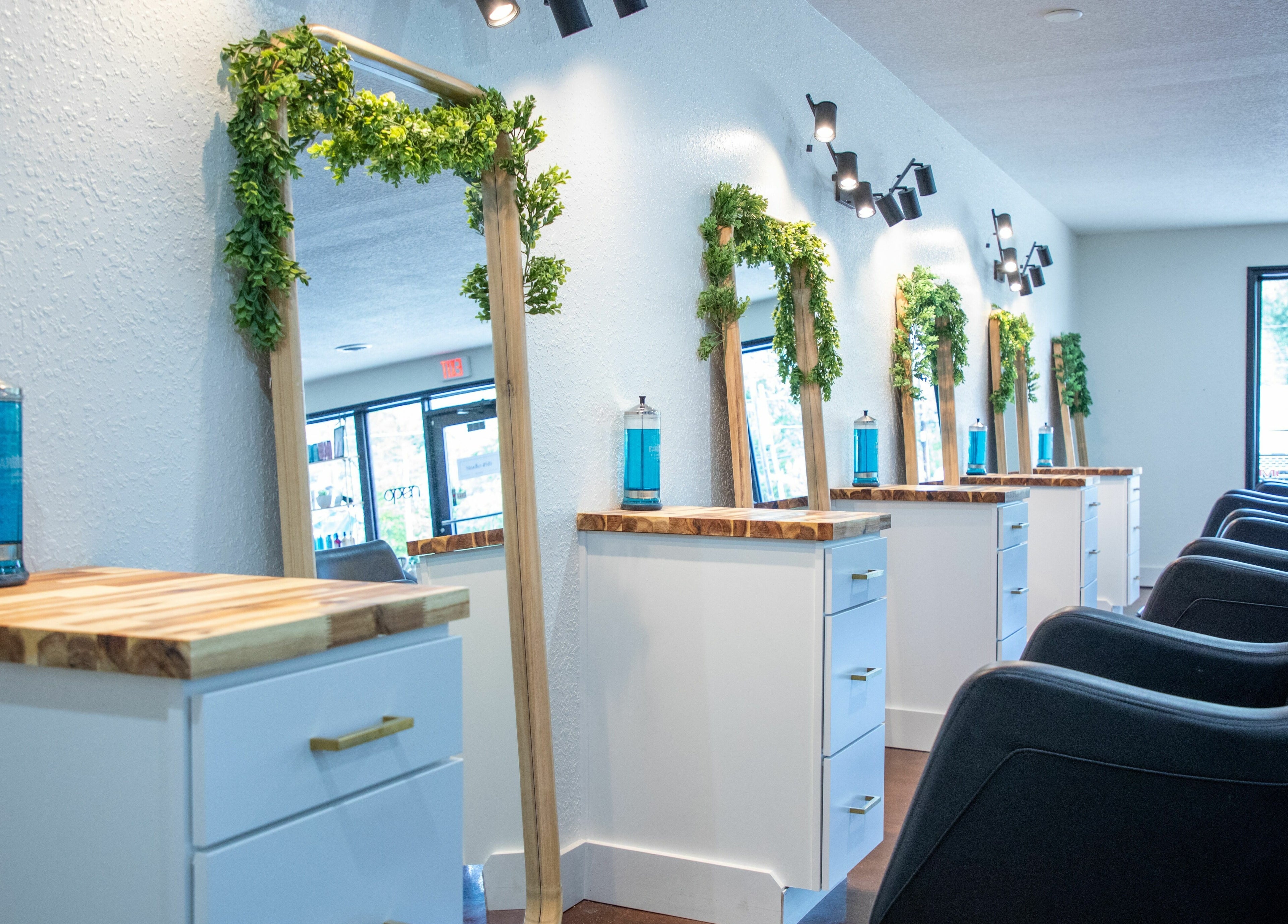 Stylish interior of Studio 45:11 Salon in Seymour, Tennessee, US featuring sleek mirrors and modern chairs.