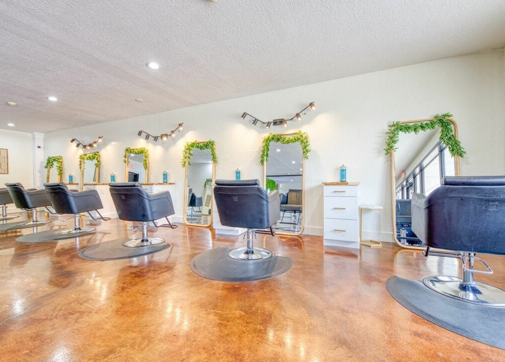 Elegant interior of Studio 45:11 Salon in Seymour, Tennessee, US with stylish chairs and mirrors.
