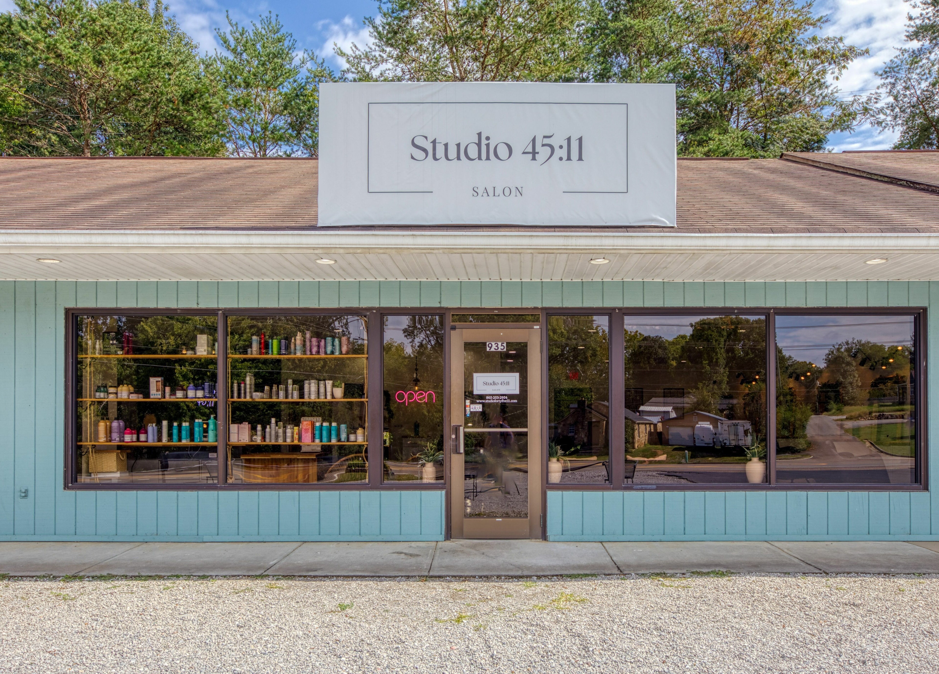 Exterior of Studio 45:11 Salon in Seymour, Tennessee, US, showcasing a modern look with large windows.