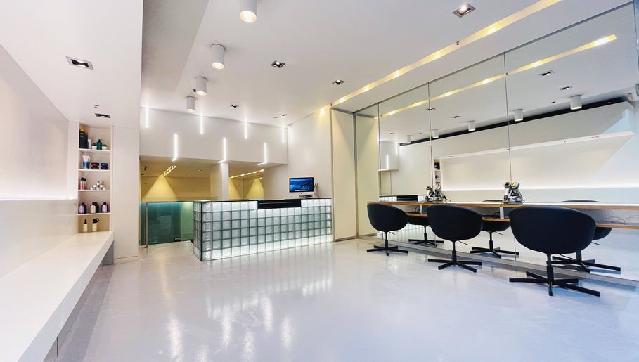 Modern interior of Devoue Hair salon in Melbourne, Victoria, AU, featuring stylish chairs and a welcoming reception.
