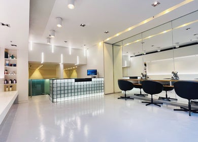 Modern interior of Devoue Hair salon in Melbourne, Victoria, AU, featuring stylish chairs and a welcoming reception.