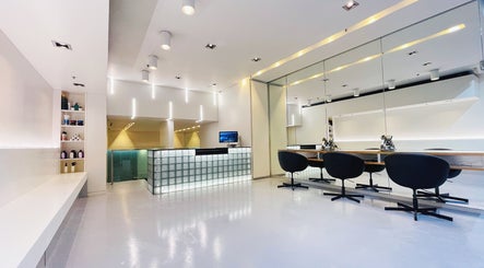 Modern interior of Devoue Hair salon in Melbourne, Victoria, AU, featuring stylish chairs and a welcoming reception.
