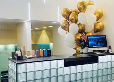 Reception at Devoue Hair adorned with gold balloons in Melbourne, Victoria, AU.