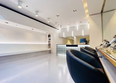 Modern interior of Devoue Hair in Melbourne, Victoria, AU showcasing plush seating and sleek décor.