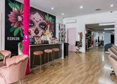 Vibrant interior of M.O.H & Co in Melbourne, Victoria, AU showcasing colorful wall art and chic seating.